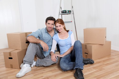 Furniture removal team handling items in a Ravenscourt Park property